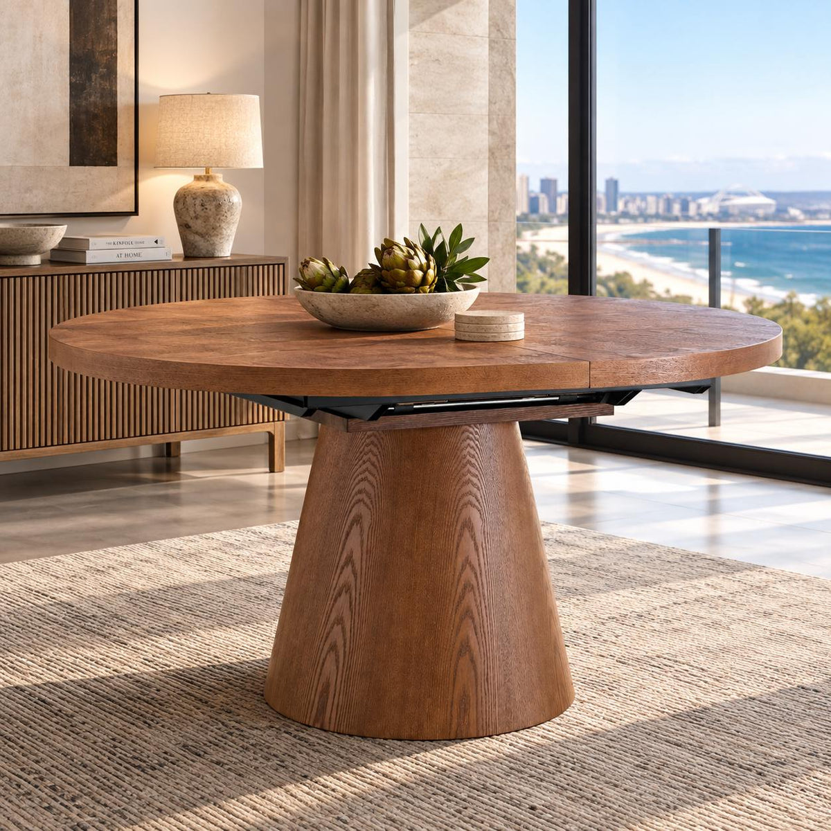 Gallery Everyday Arden Dining Table in Walnut, featuring a round extendable walnut veneer top and broad tapered pedestal base.