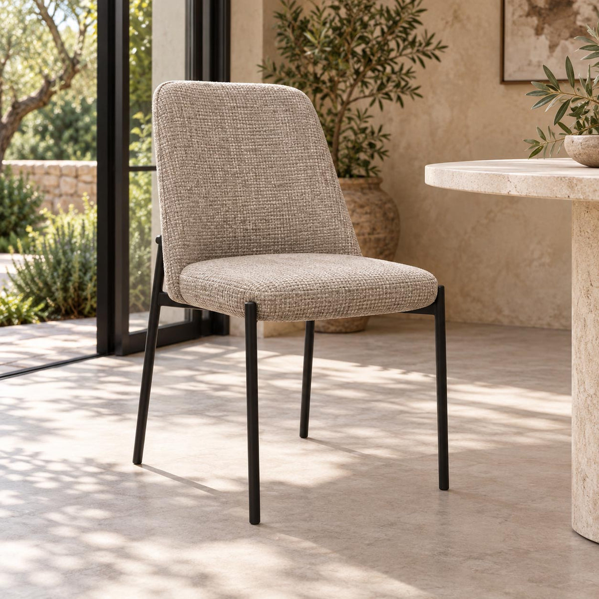 Gallery Everyday Monroe Dining Chair in Oxford Tan, featuring warm tan fabric upholstery, a gently curved backrest and slender black metal legs.
