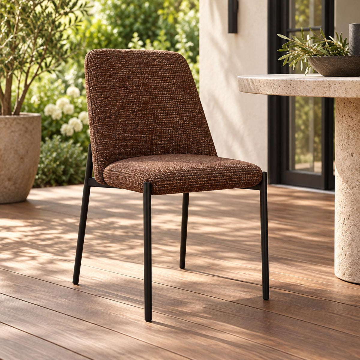 Gallery Everyday Monroe Dining Chair in Roasted Hazelnut, featuring warm brown fabric upholstery, a gently curved backrest and slender black metal legs.