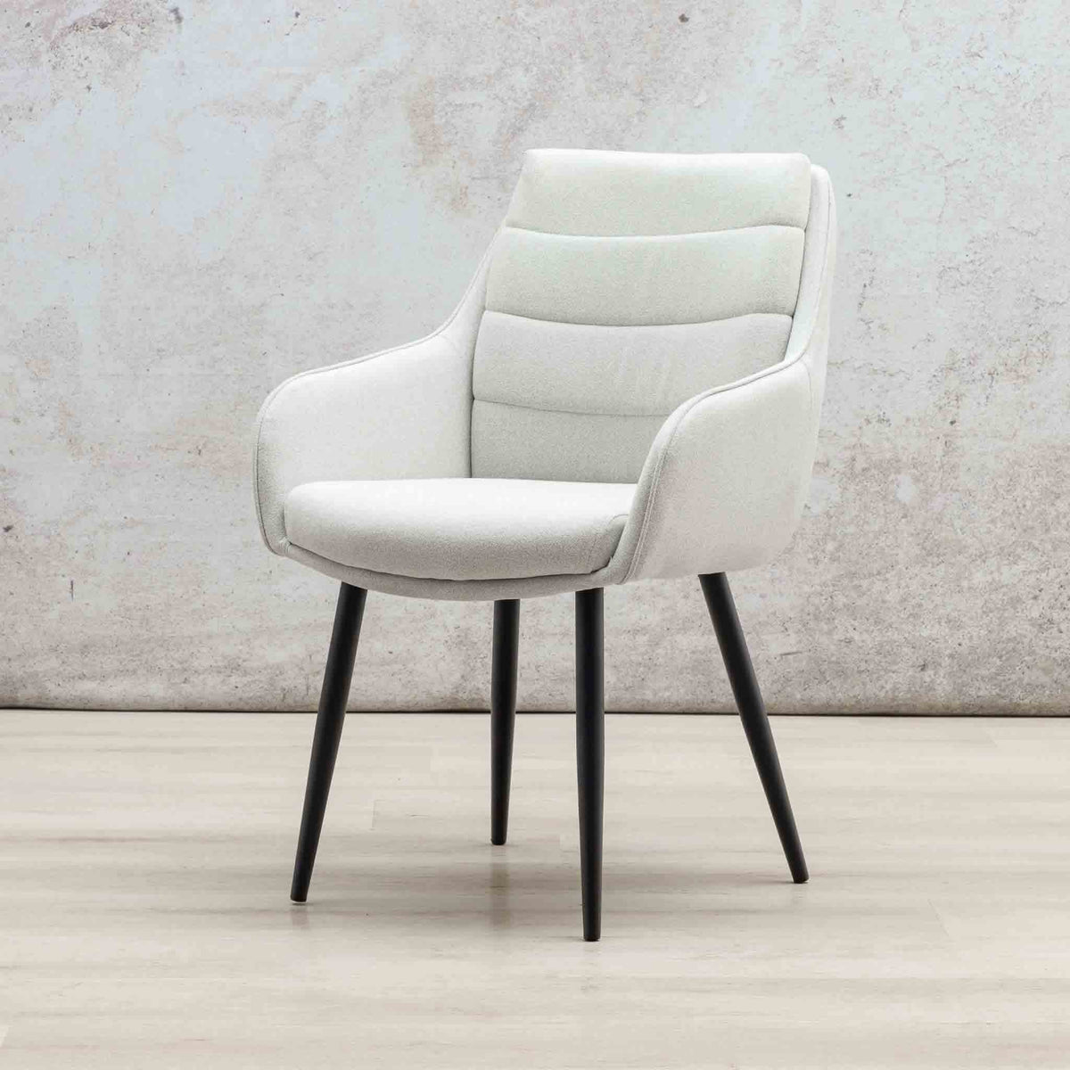 Gallery Everyday Octavia Fabric Dining Chair in Light Grey, featuring a high curved backrest, padded armrests, and tapered black legs.