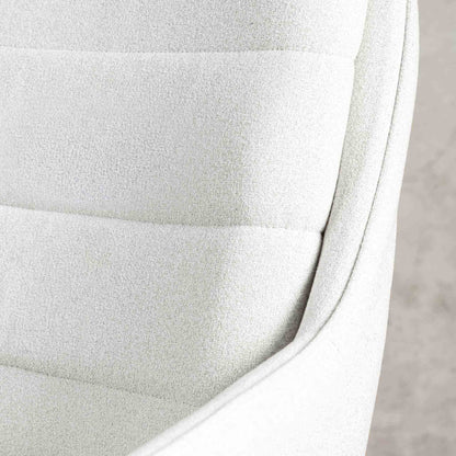 Close-up of the Gallery Everyday Octavia Fabric Dining Chair in Light Grey, showing horizontal channel stitching and the curved upholstered armrest.
