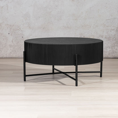 Armstrong Coffee Table, a black drum-style coffee table with slender metal X-frame legs. modern coffee table, wood coffee table