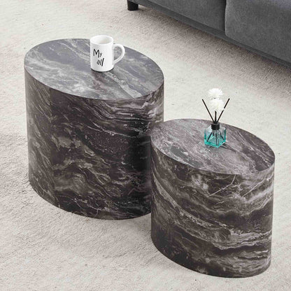 Gallery Everyday Callaway Coffee Table Set of 2, featuring cylindrical marble-look tables styled with a mug and small plant on a light grey carpet.