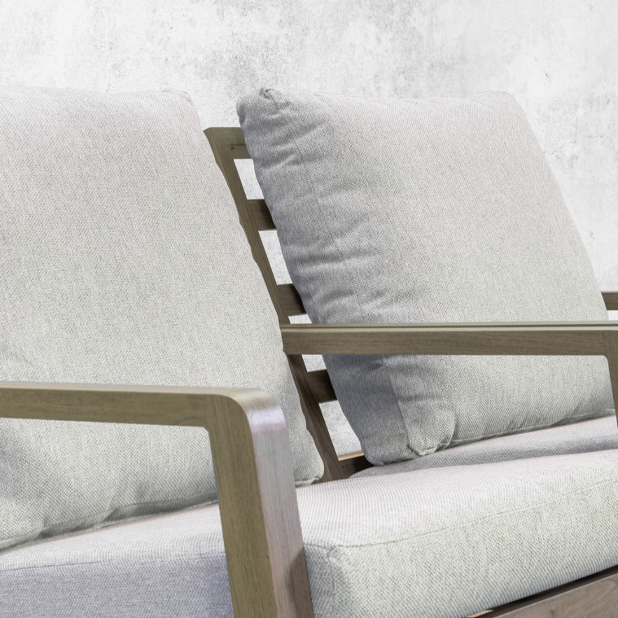 Close-up of the Syracuse suite's grey scatter cushions against its slatted weathered-wood frame