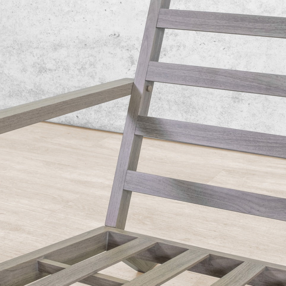 Detail of the Syracuse lounge suite's weathered grey slatted timber frame and armrest